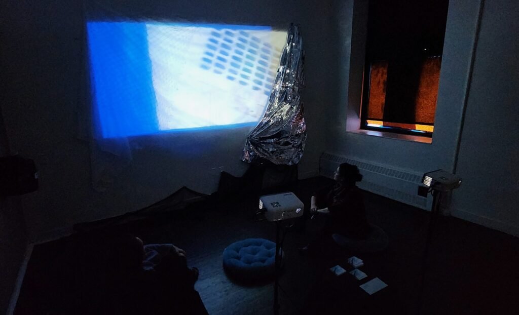 image showing viewers experiencing PERCEPTION, with two projectors in a dark room